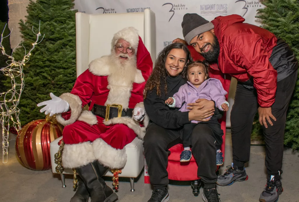 Family posing for photos with Santa